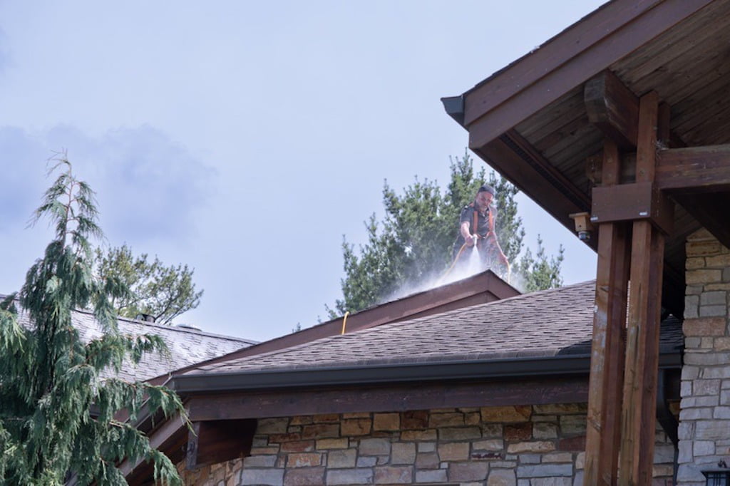 A Roof Maxx dealer applies the treatment to a customer's roof.