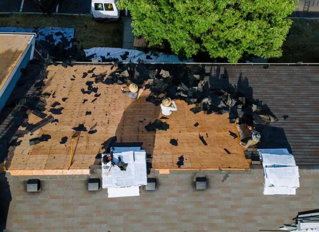 A residential asphalt shingle roof in the middle of a tear-off