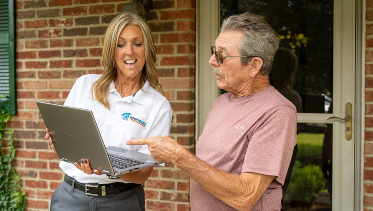 A Roof Maxx dealer shows a customer the value of Roof Maxx treatments