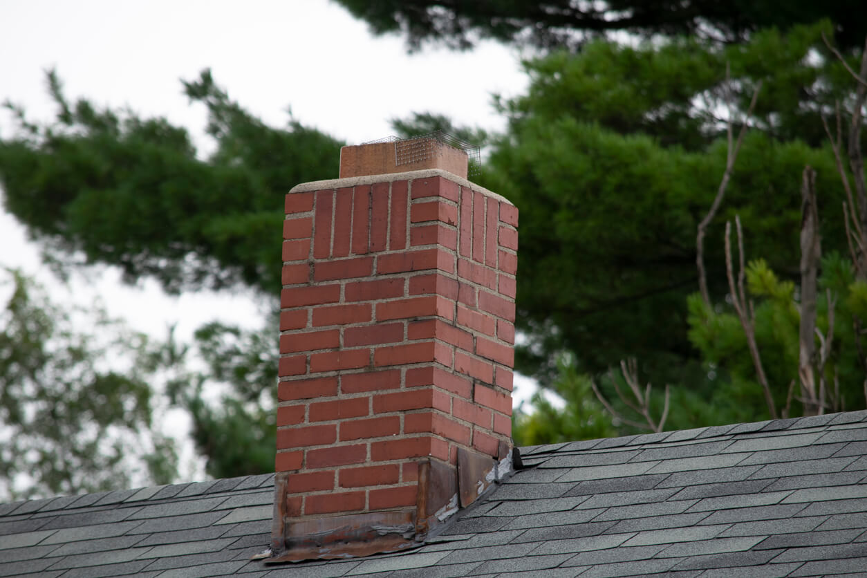 Flashing around a chimney with clear signs of wear and tear.