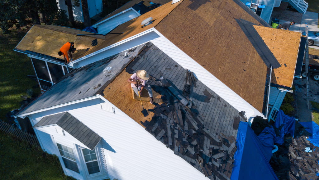 Top-down of an asphalt shingle roof in the middle of replacement