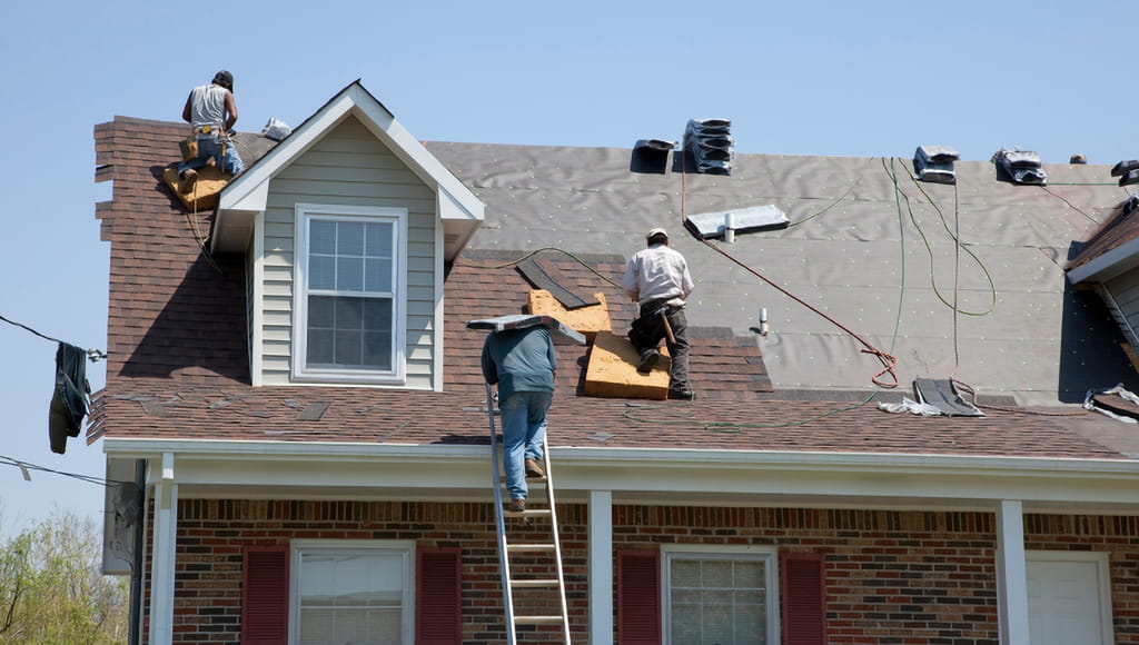 Roofers working on a customer's residential roof