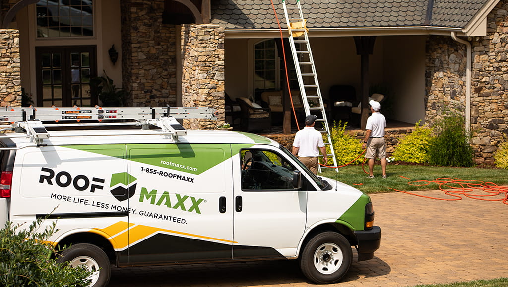 A RoofMaxx truck in front of a customer's house, showing edge flashing.