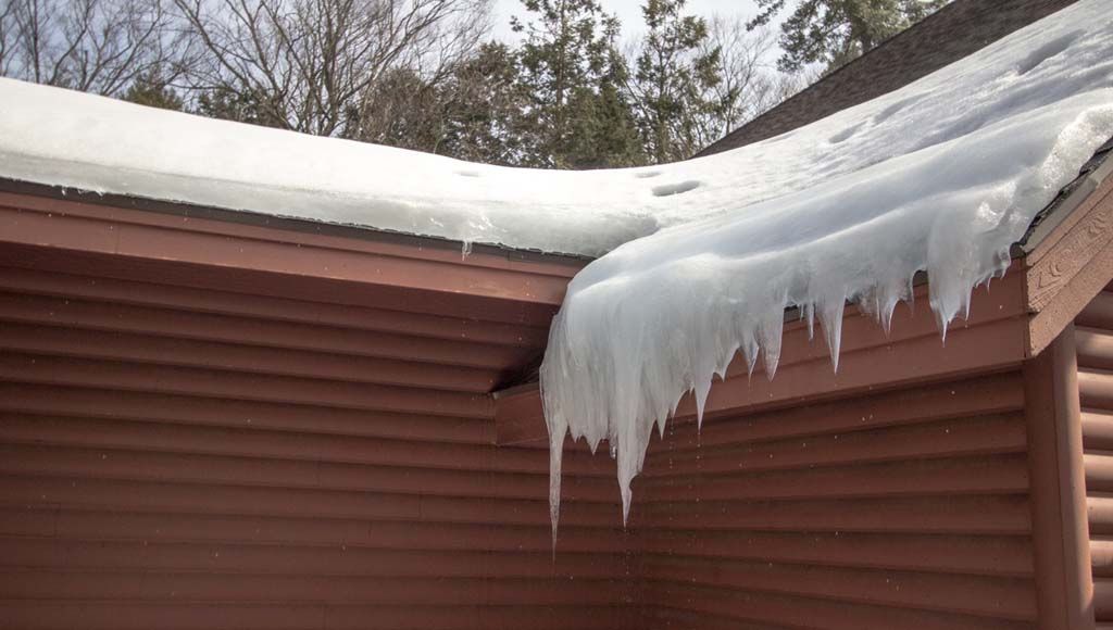 Ice dams on roof to represent potential threat to shingle lifespan.