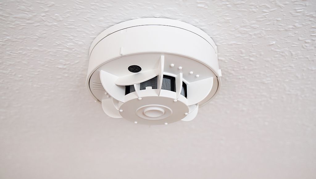 Close-up angled photo of a combination smoke and carbon monoxide detector.