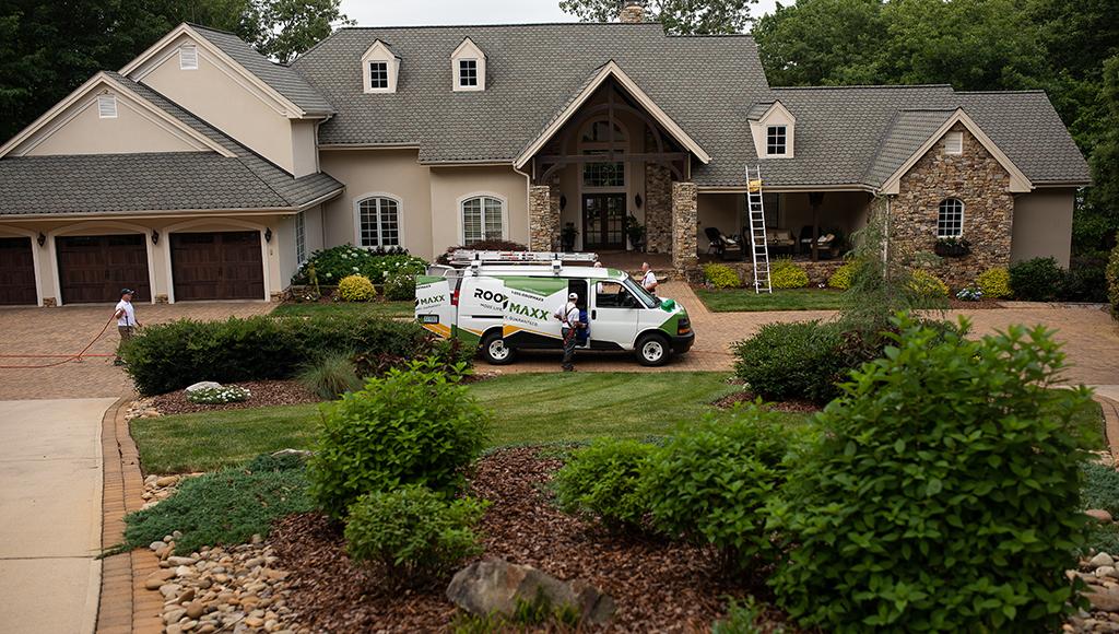 Roof Maxx dealers treat a home surrounded by trees.