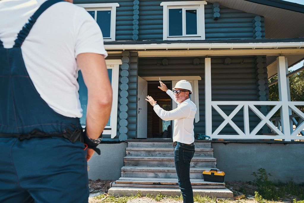 Home inspectors standing outside house before job