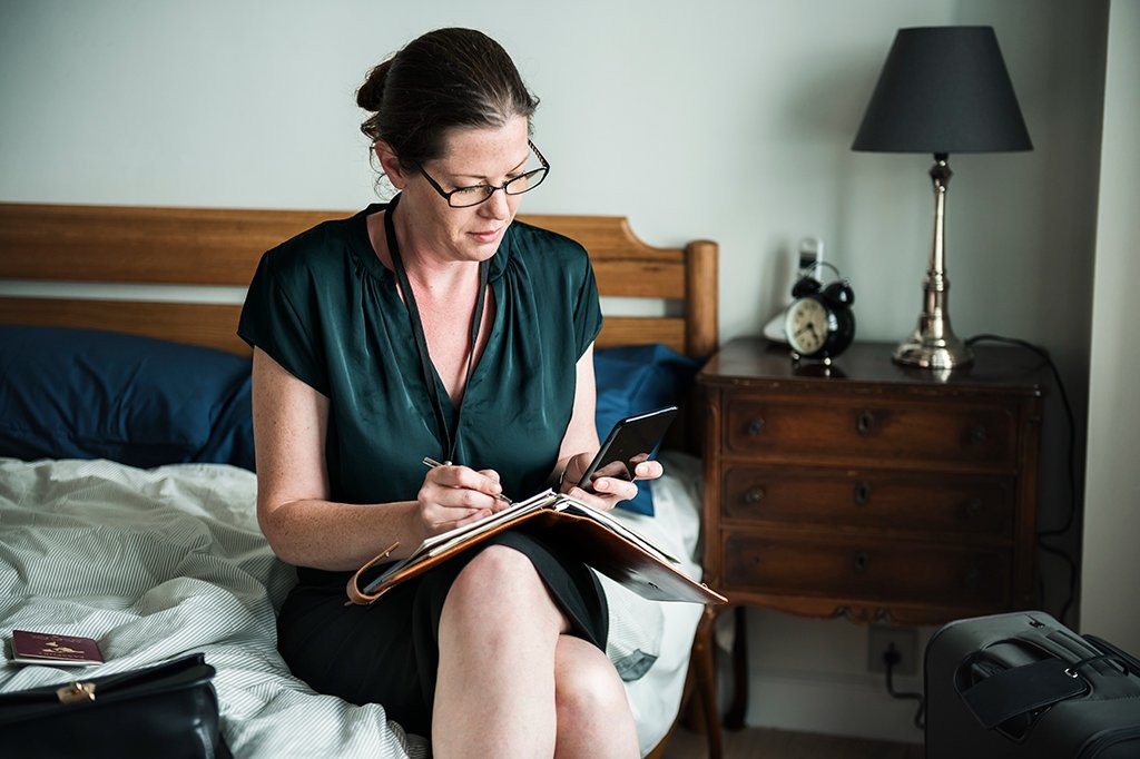 A woman documents photos, videos, and dates for her home insurance claim