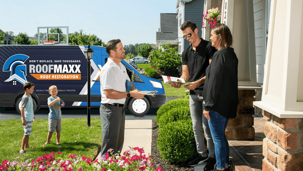 A Roof Maxx dealer explains the Roof Maxx treatment process to homeowners.