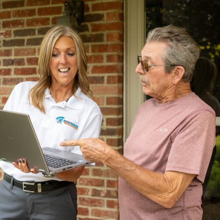 A Roof Maxx dealer shows a customer their roof score